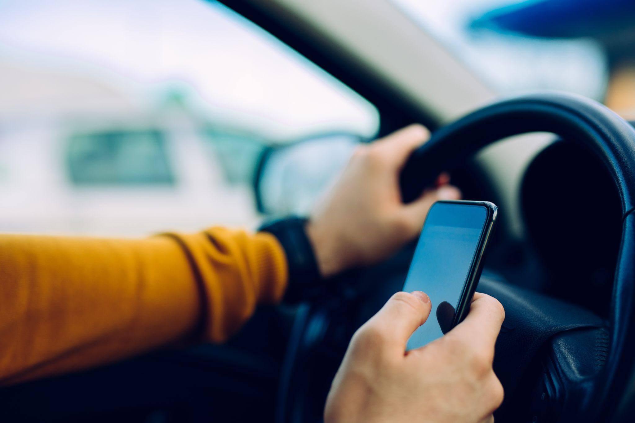 Driver distracted by cell phone in car, a common