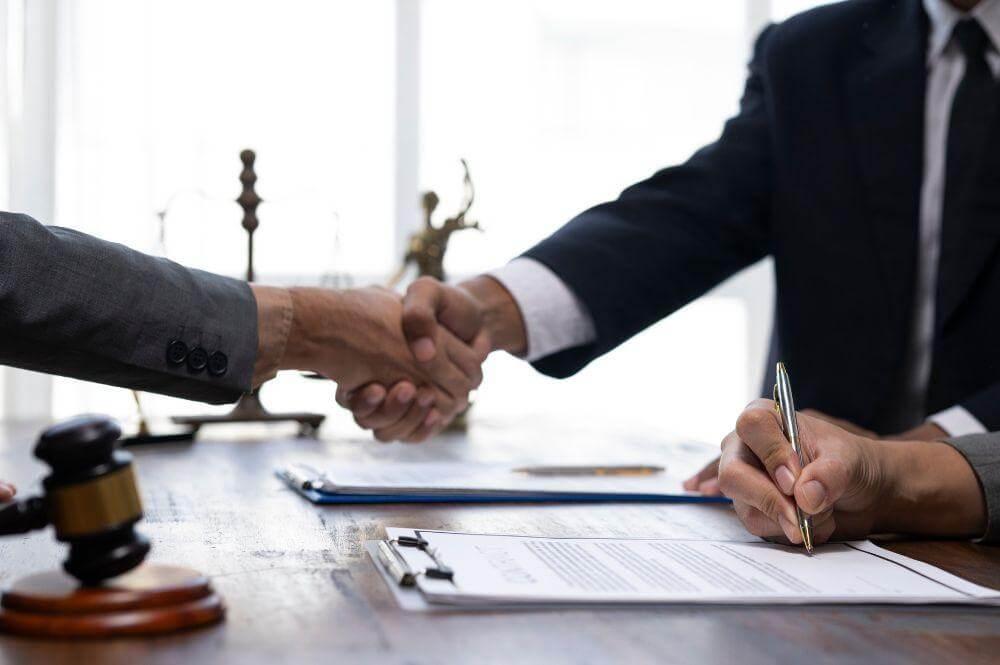Florida car accident lawyer shaking hands with a client over a table